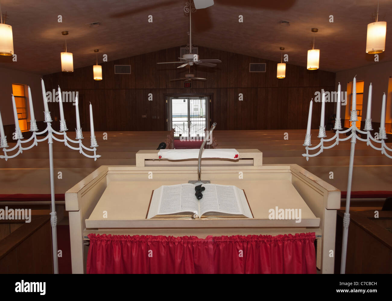 Candle stands, open bible on a pedestal inside a small Baptist Church in USA Stock Photo