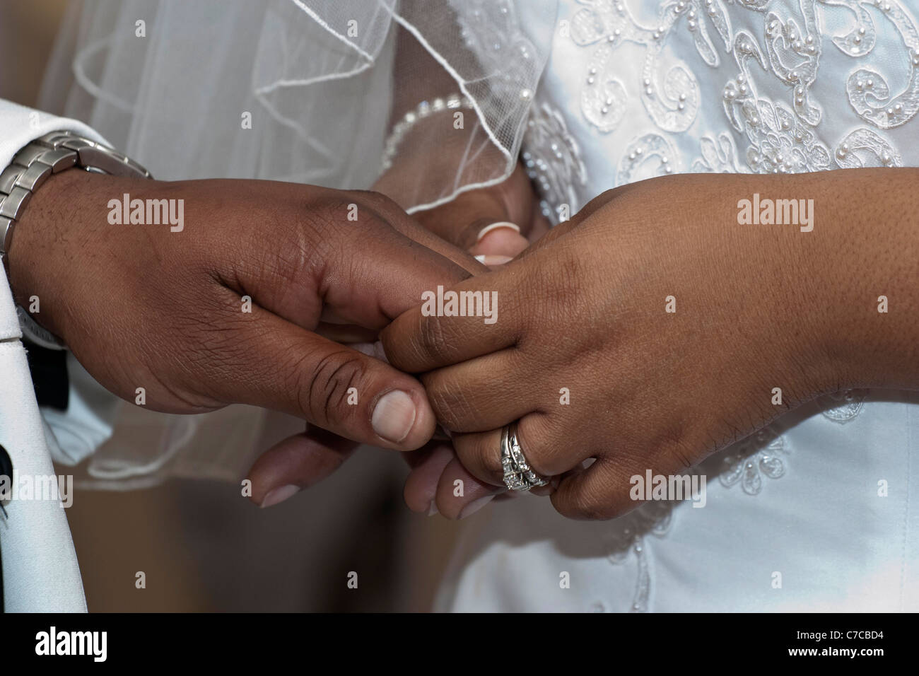 The Church African American wedding ceremony couple a groom with bride showing off their hands with wedding rings pictures in USA US horizontal hi-res Stock Photo