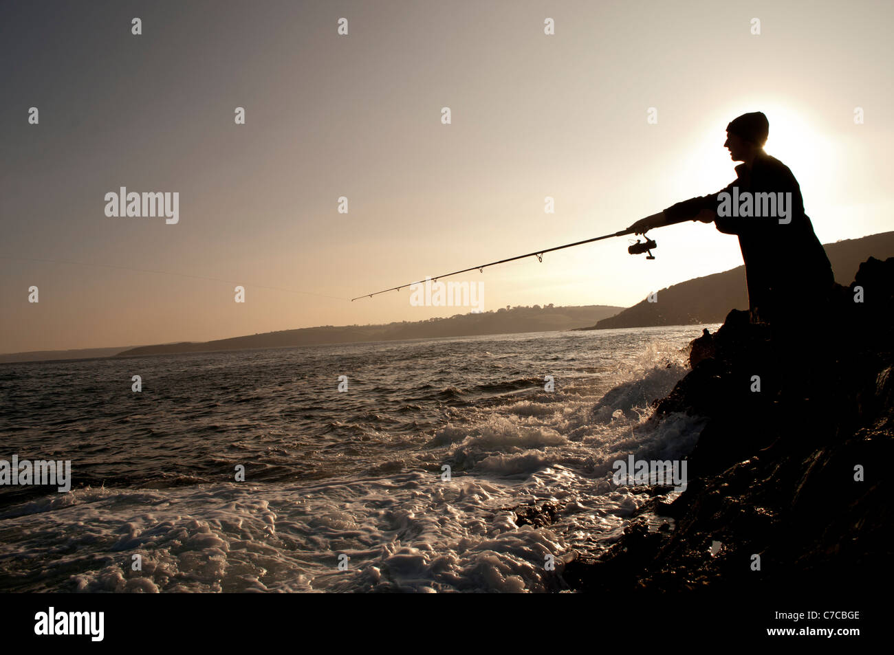 Fishing at sunset Stock Photo - Alamy