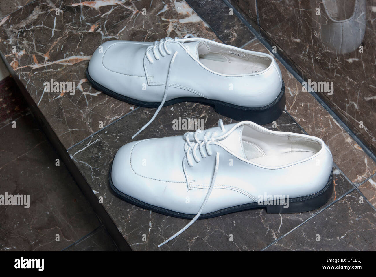 A pair of white shiny man's wedding shoes Stock Photo