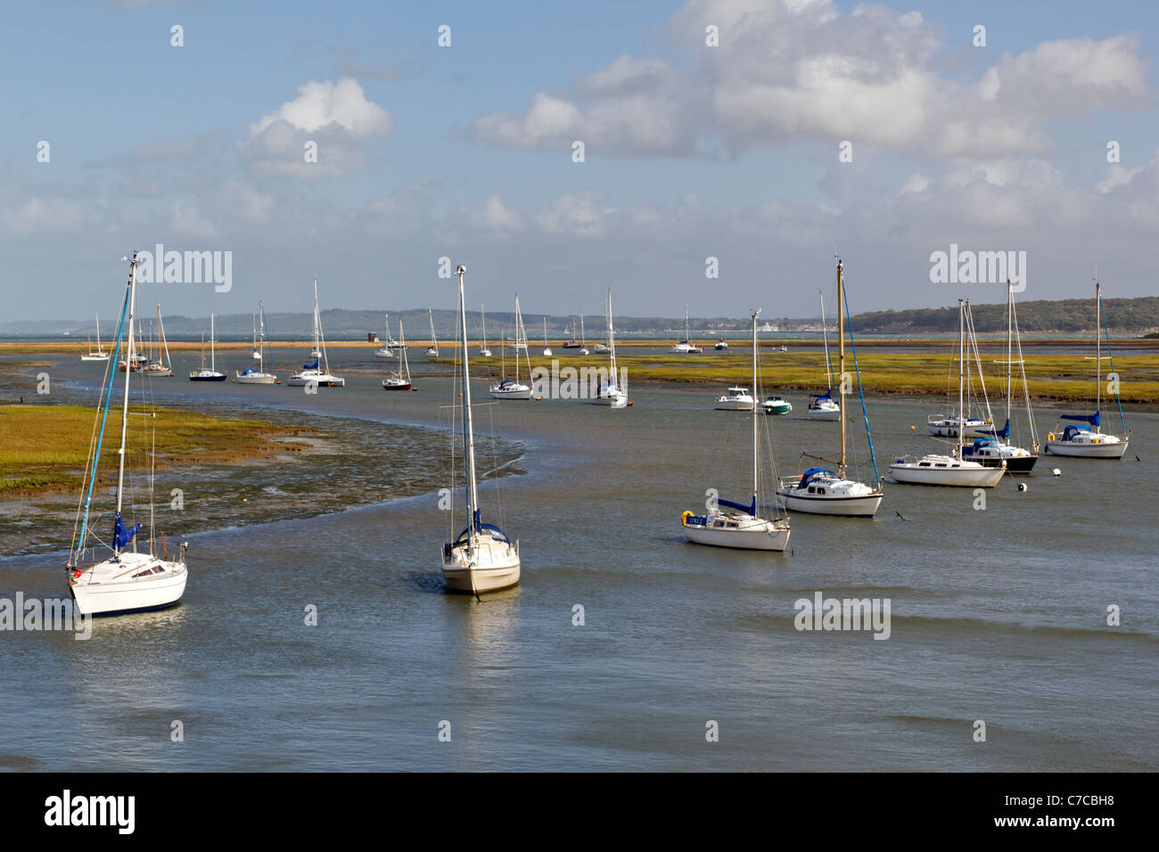 S-shape view of Moored Yachts and Boats in tidal estuary at Hurst Castle Spit near Keyhaven Yacht Club, Milford On Sea Stock Photo