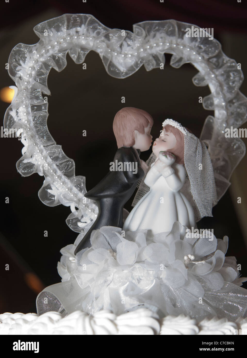 Decorative wedding cake topper bride and groom figurines kissing each