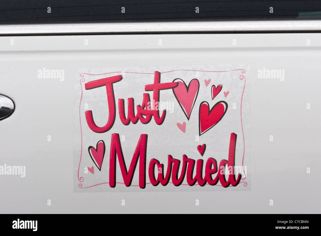 Side close-up view of Just Married sign on white limousine door Stock Photo