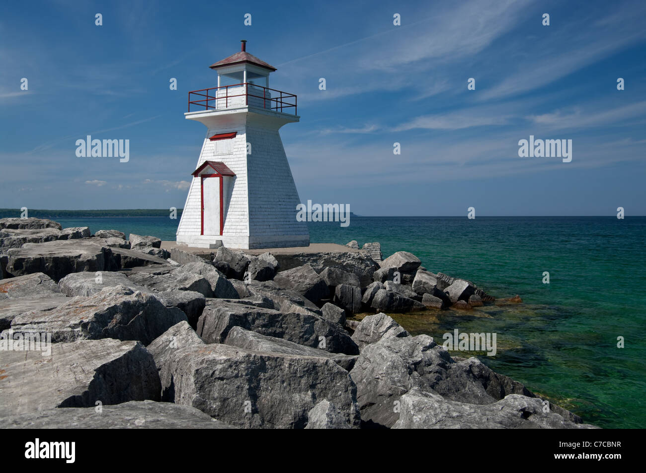 Lighthouse on a Rocky Breakwall Stock Photo