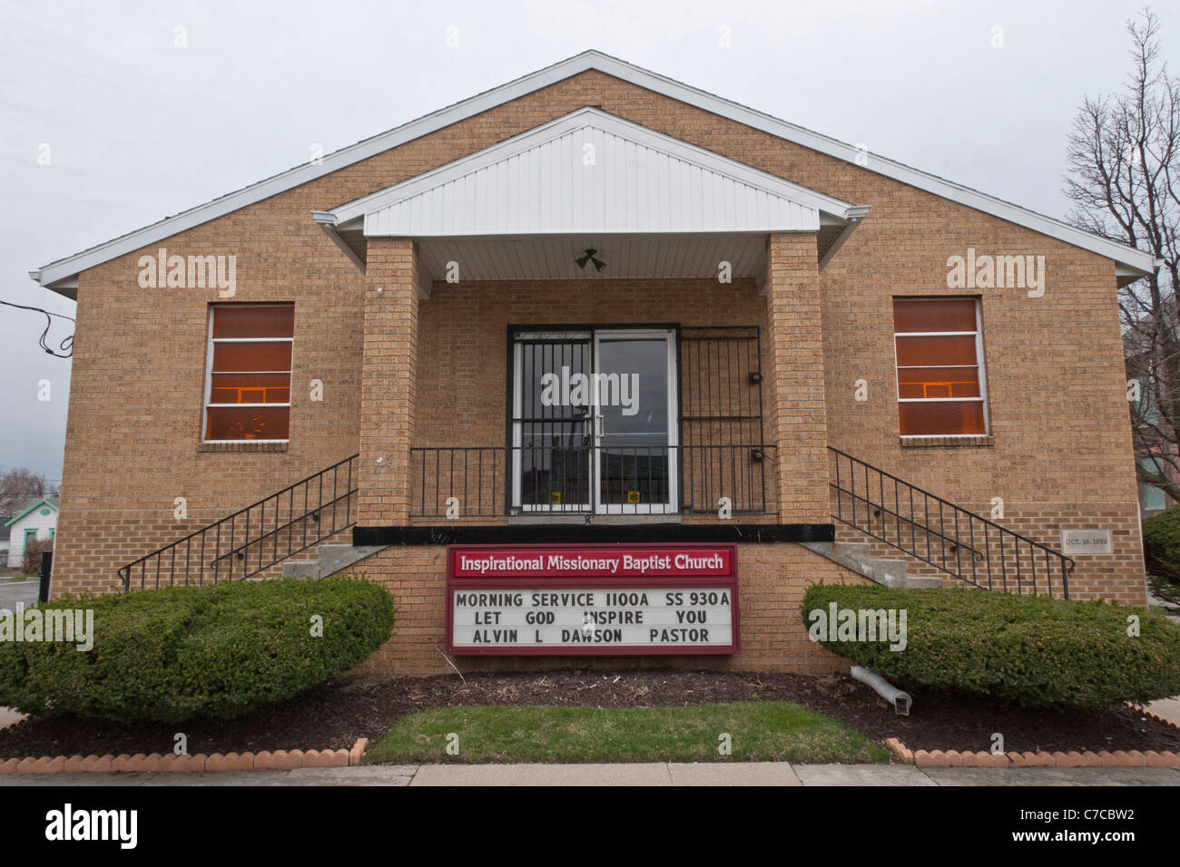 Outside front low angle view of small brick Baptist church in USA Stock Photo