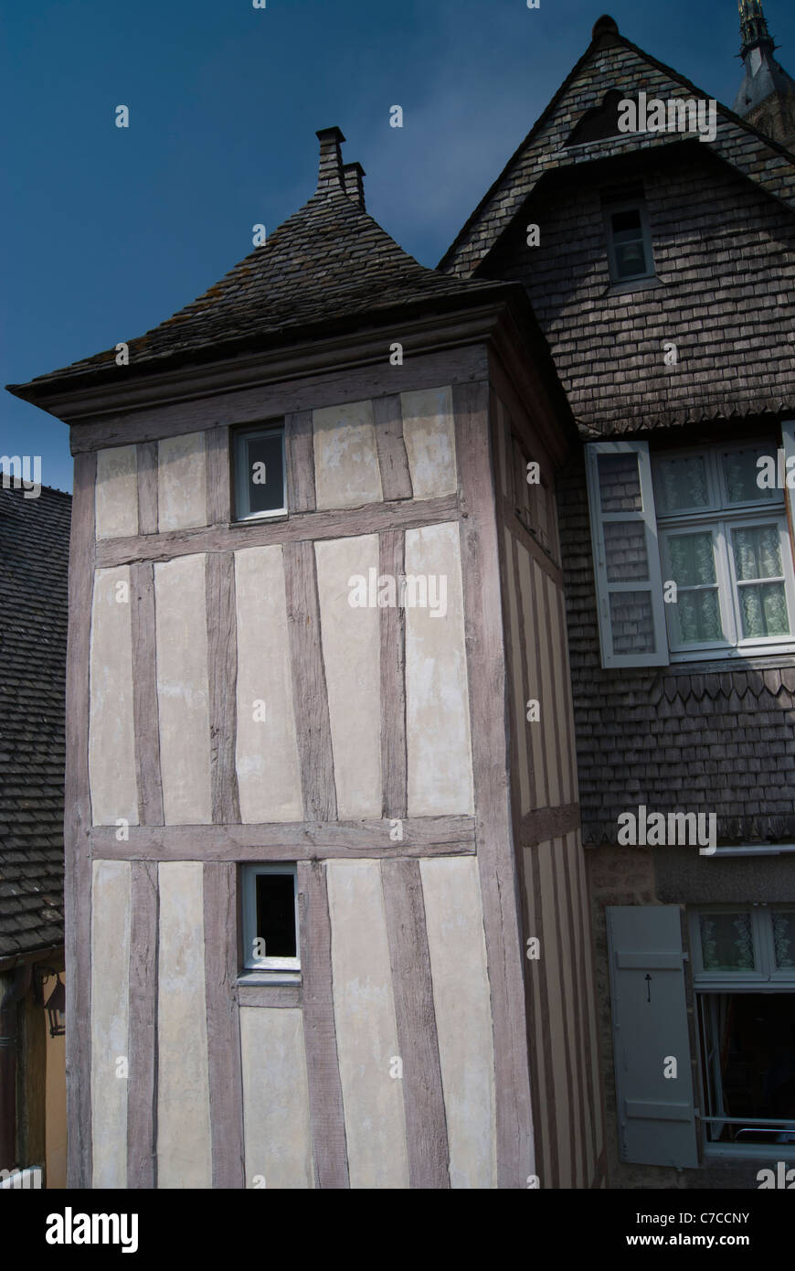 Half timbered narrow buildings with slate roofs and wooden shingles in town of Mont Saint Michel. Stock Photo