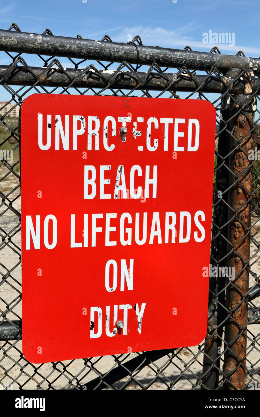 A warning sign indicating no life guards on duty at a oceanfront section of a Monmouth County Park, long Branch, New Jersey, USA Stock Photo