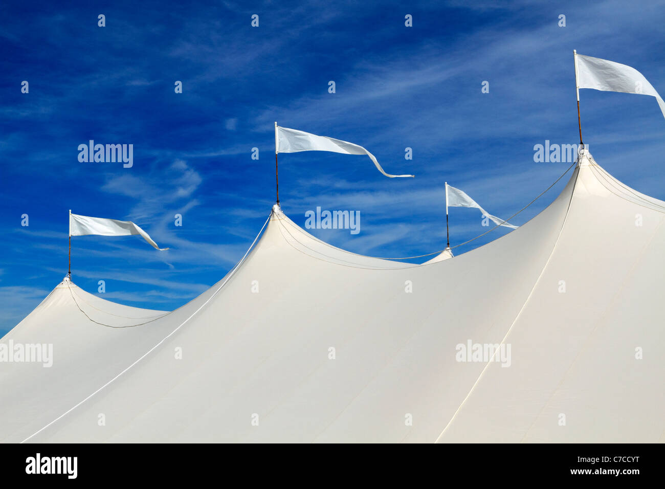 The top of a large event white event tent in front of a blue sky. On the beach in Long Branch, New Jersey, USA Stock Photo