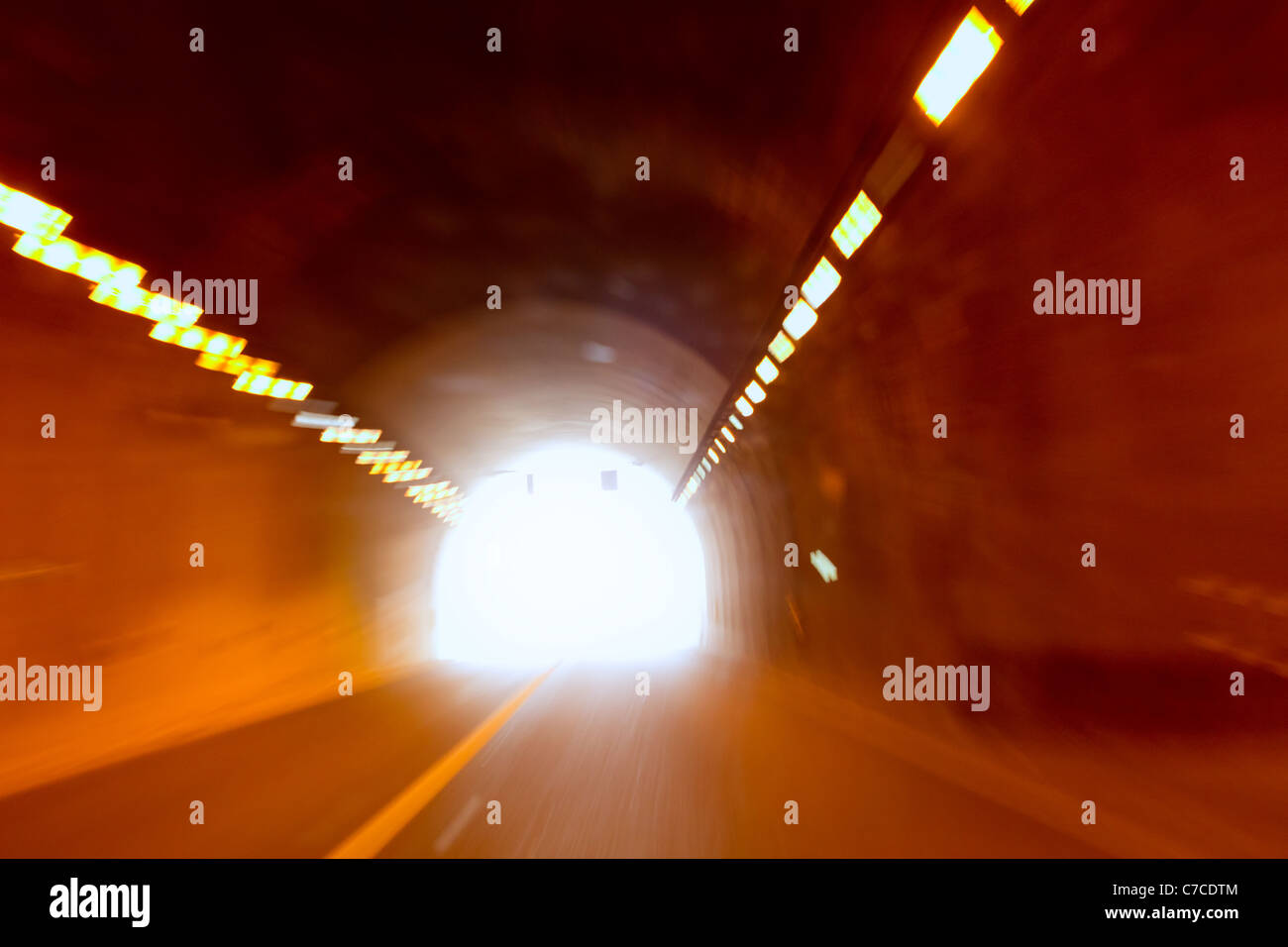blurred motion tunnel like driving drunk metaphor with light at the end Stock Photo