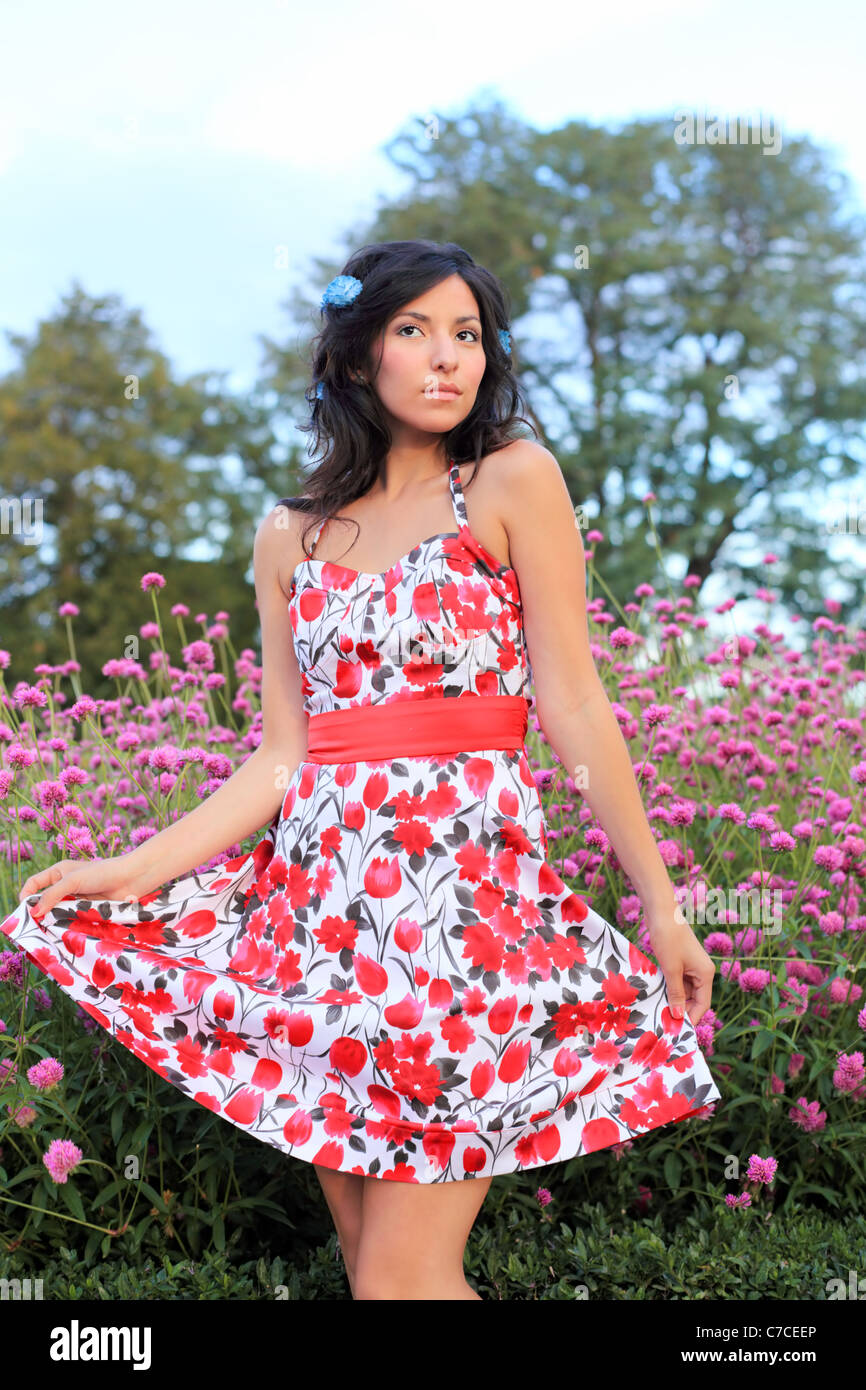 A young woman displays her cute flowery dress Stock Photo - Alamy