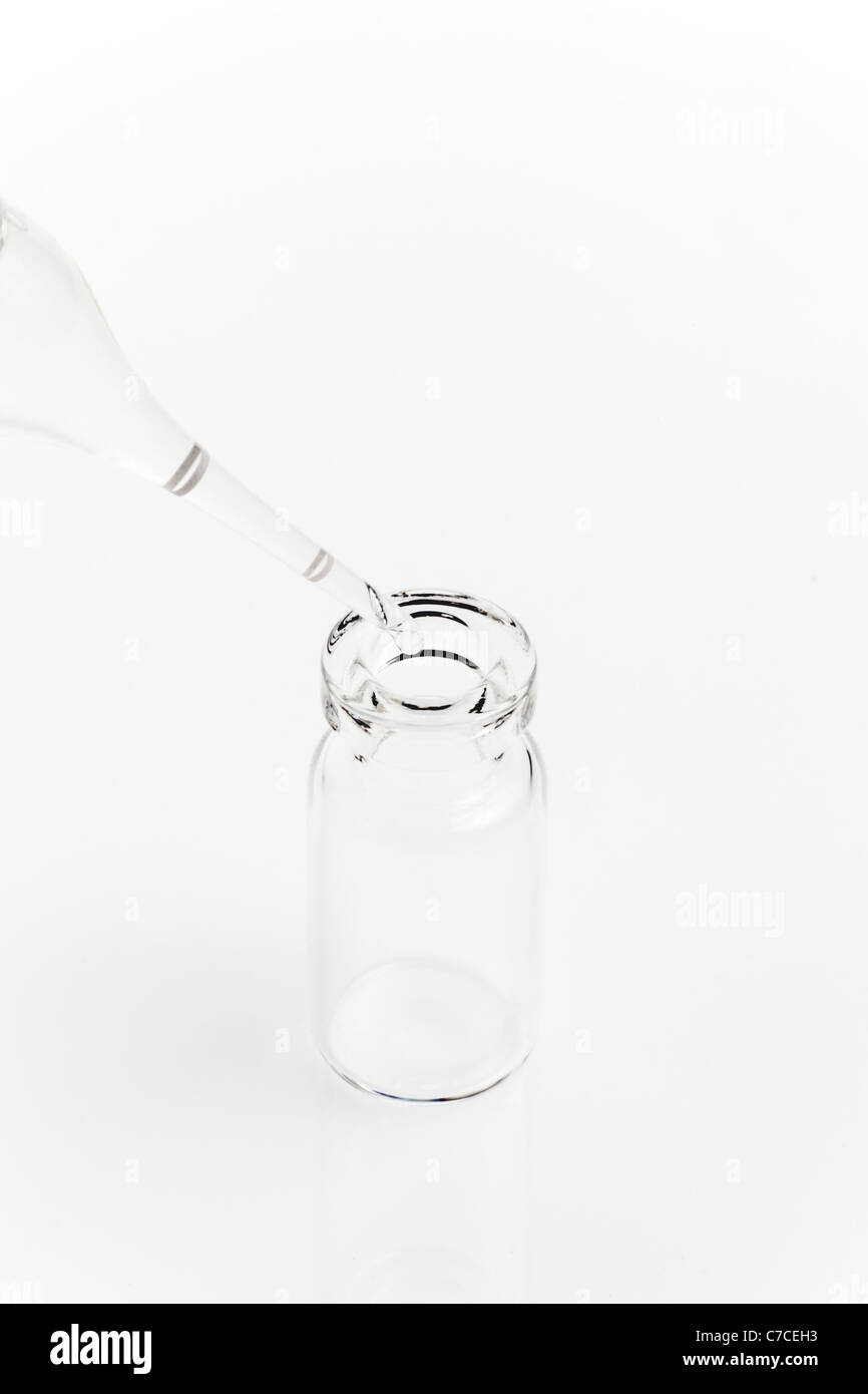 A glass ampule being filled with medication Stock Photo