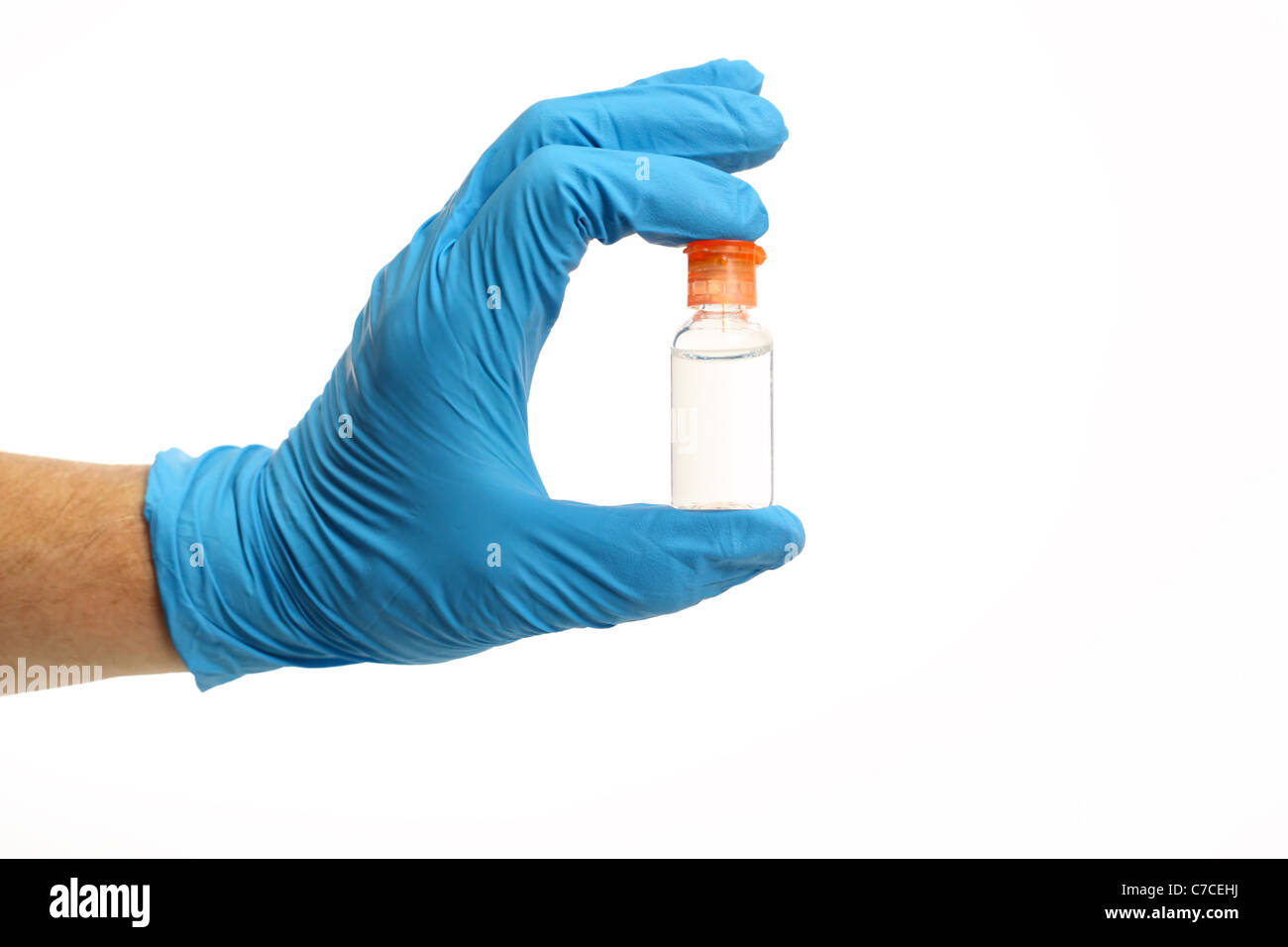 A gloved hand holding a vial between two fingers over a white background Stock Photo