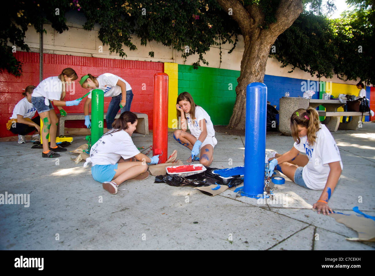 Volunteers paint decorations in a city playground during a community beautification program in Santa Ana, CA. Stock Photo