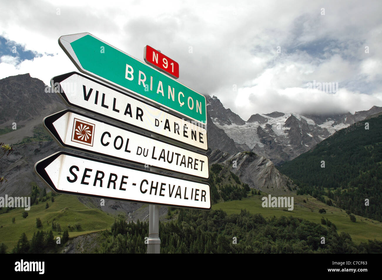 Direction sign at La Grave in France - the International off piste ski area which can be seen in the distance during the summer. Stock Photo