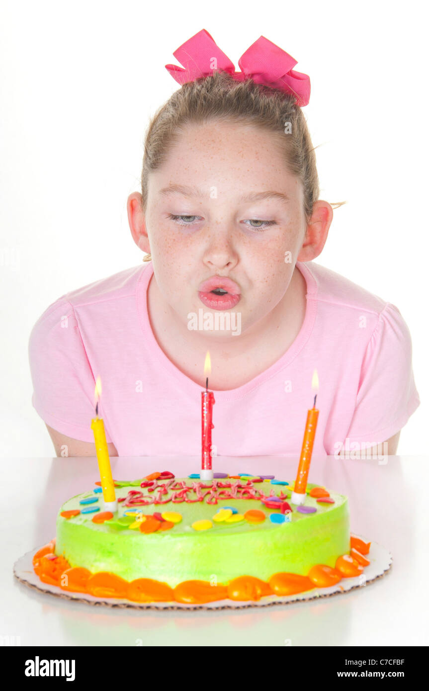 Girl blowing out birthday candles Stock Photo Alamy