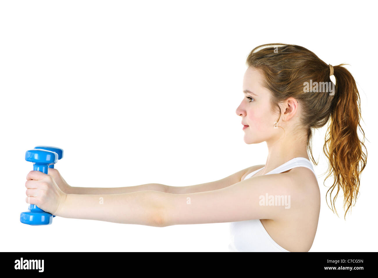 Determined healthy fit young woman lifting weights for fitness exercise Stock Photo