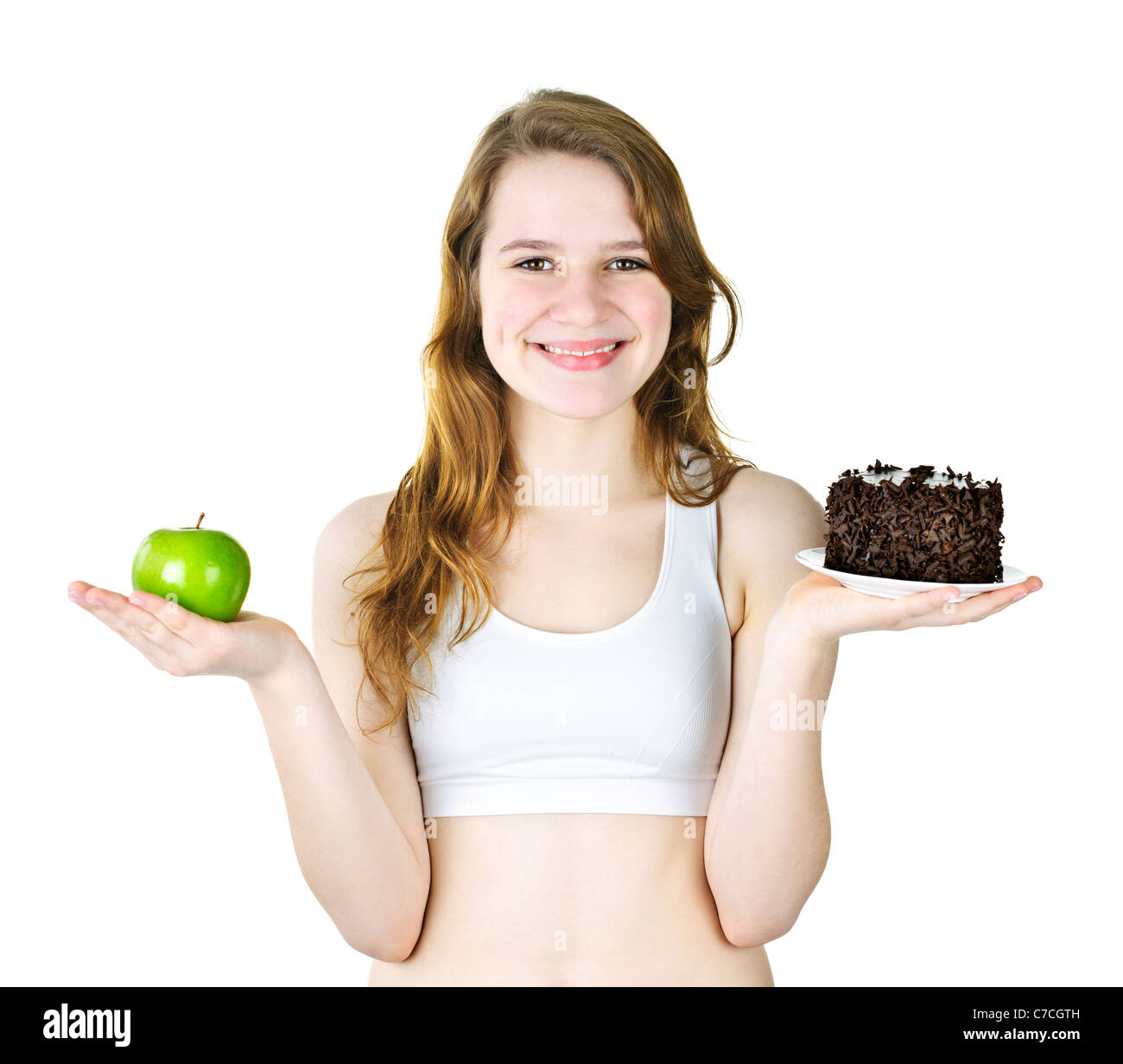 Smiling young woman holding apple and chocolate cake Stock Photo
