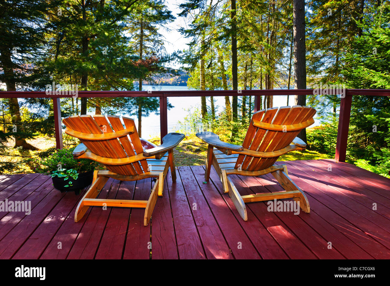 Wooden deck at forest cottage with Adirondack chairs Stock Photo - Alamy