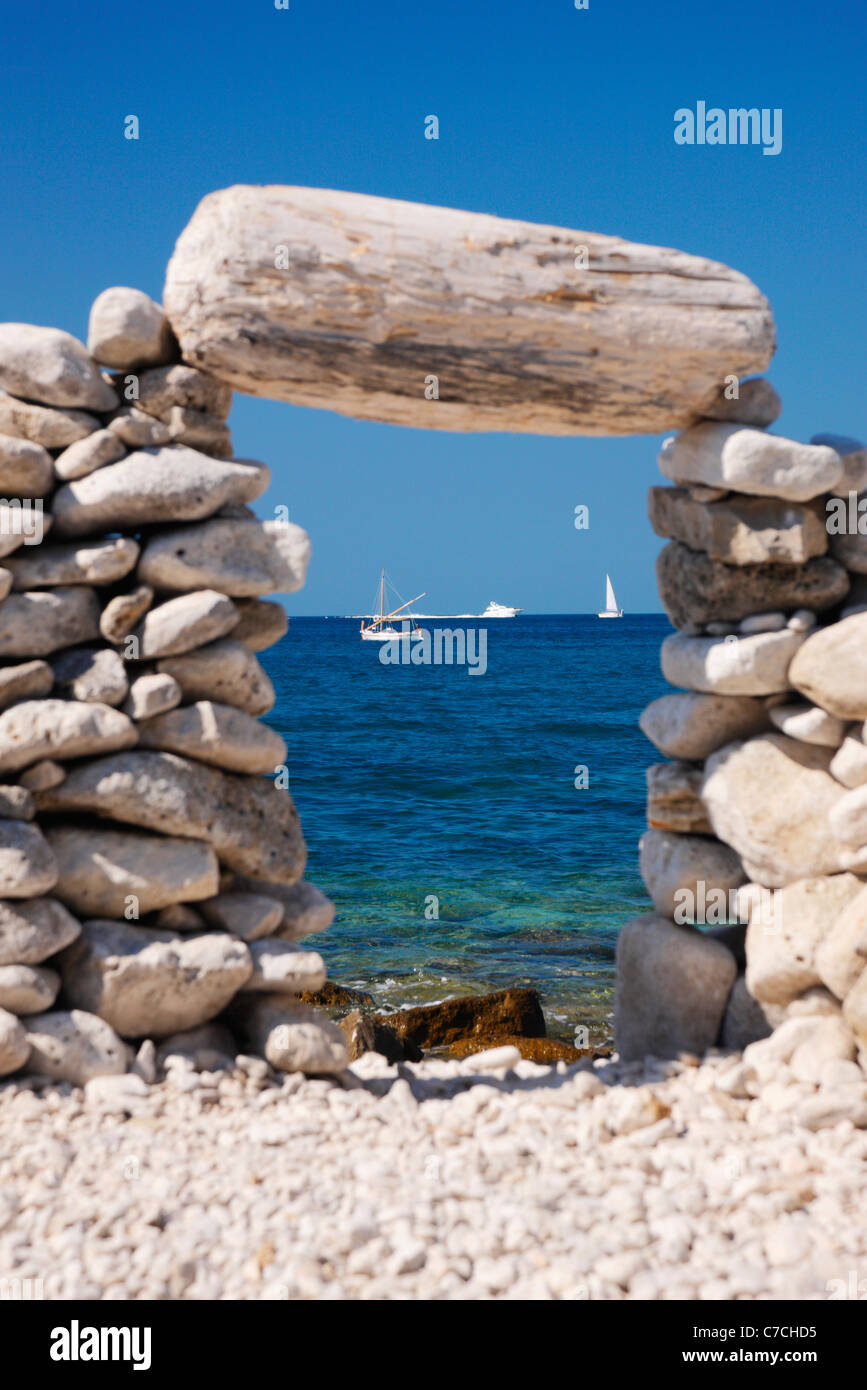 Beach scenic. Arch of stones on the beach Stock Photo