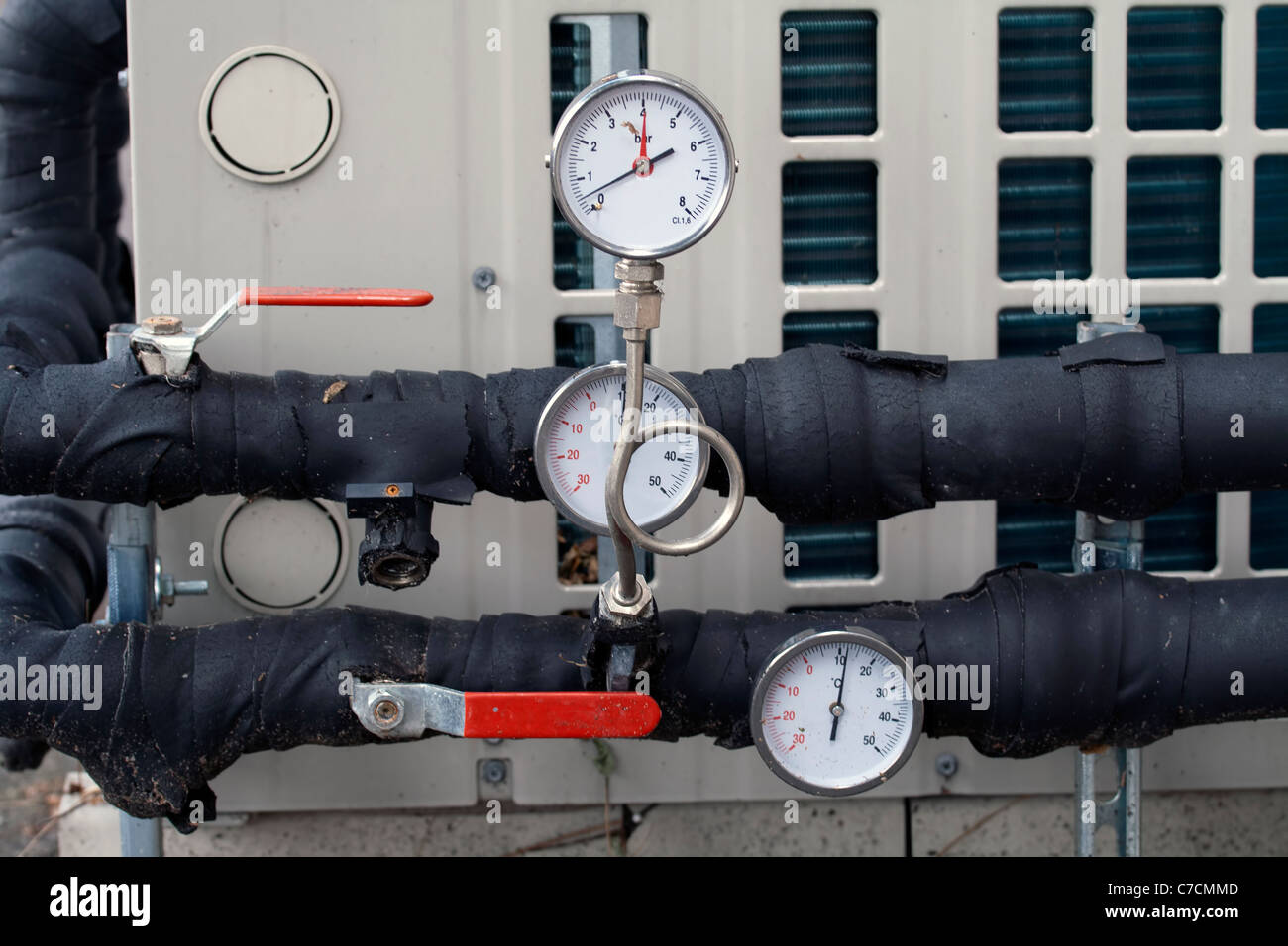 Industrial pressure gauges and pipes in the background Stock Photo - Alamy