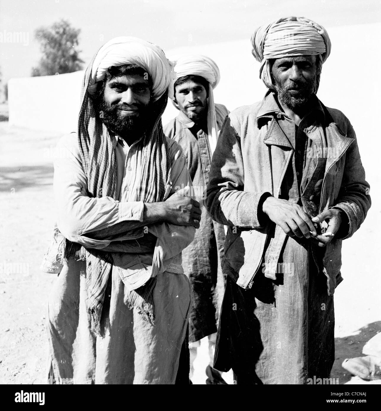 Three tribesmen or pashtuns wearing turbans and robes stand for picture, Dhadar Pakistan. Taken in the 1950s by J. Allan Cash. Stock Photo