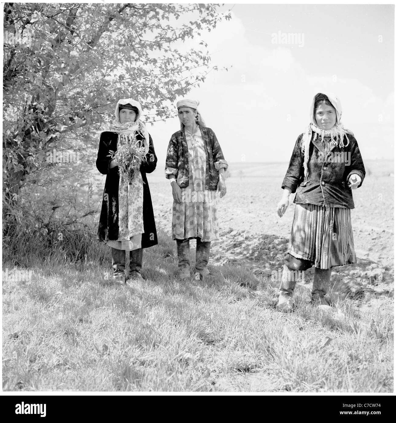 Historical picture from 1950s of three Russian women wearing robes walking in a field. Stock Photo