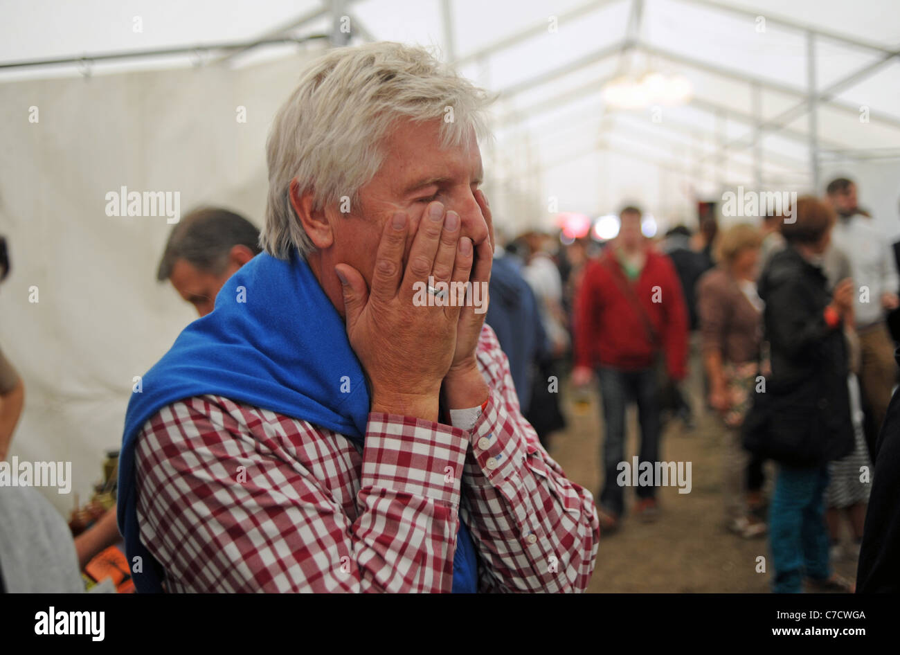 Man holds his face in pain after eating a hot chilli at the Fiery Food Festival in Brighton UK Stock Photo