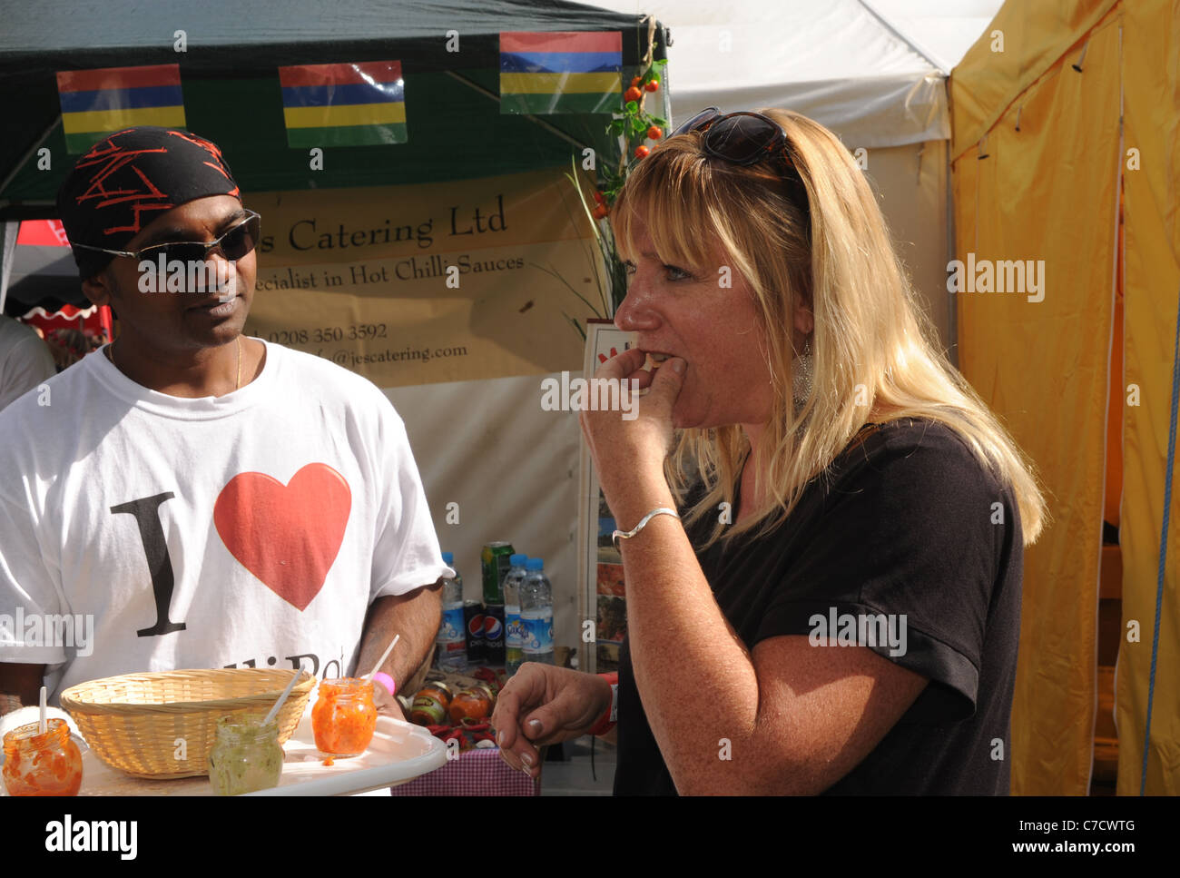 Woman trying a hot chilli at the Fiery Food Festival in Brighton UK 2011 Stock Photo