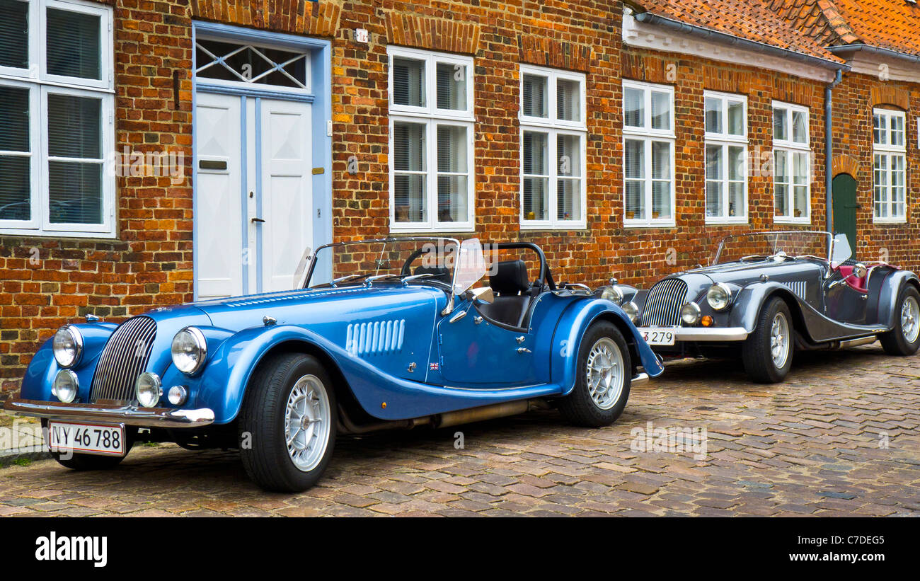 A pair of Morgan sports cars outside residential house in Ribe old town, Jutland, Denmark Stock Photo