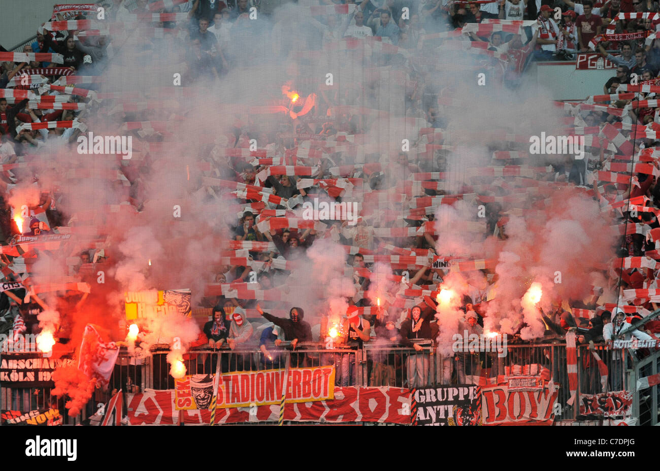 football fans burn red flares Stock Photo