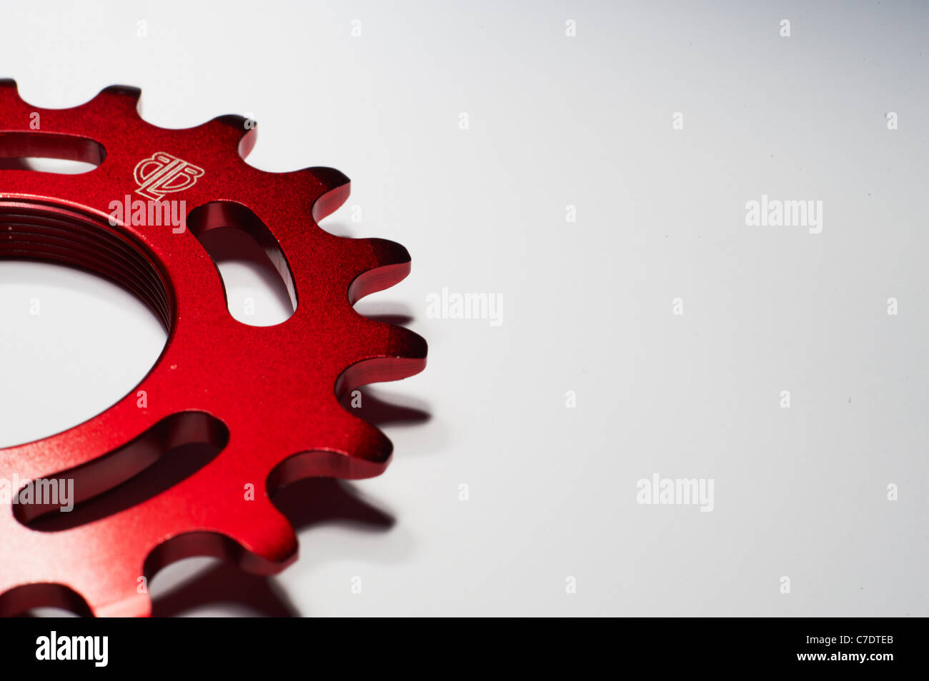 red anodised fixed gear sprocket cropped from left Stock Photo