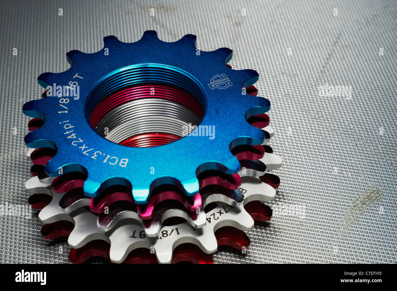 Selection of anodised fixed gear sprockets Stock Photo