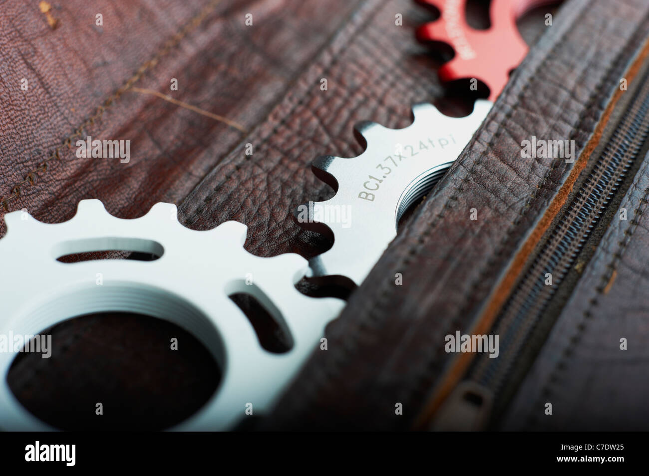 sprockets and cogs for bike in leather satchel Stock Photo Alamy