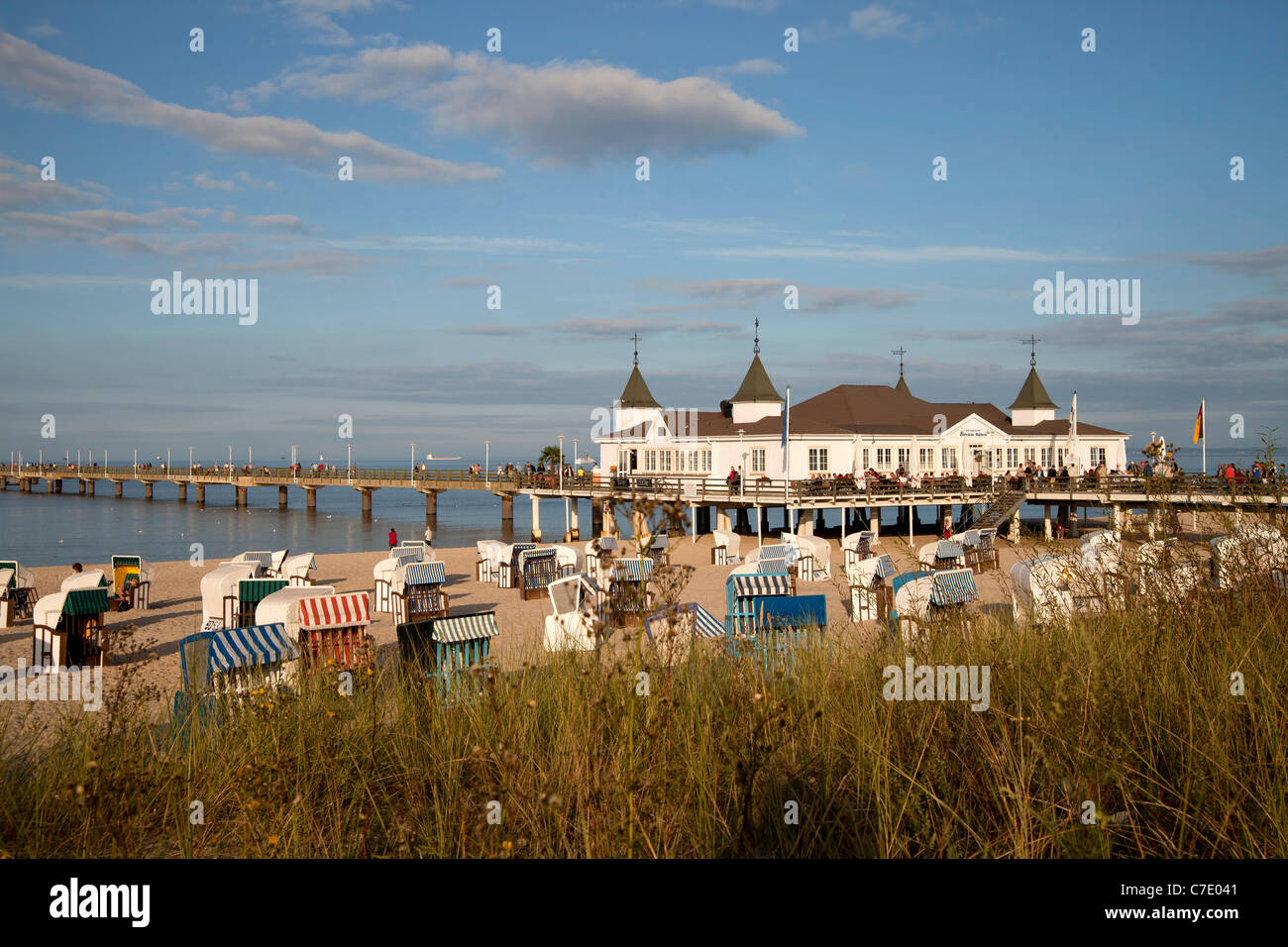 Beach chairs ' Strandkorb ' and the Seebruecke or Pier at the baltic beach of the seaside resort Ahlbeck, Usedom island, germany Stock Photo