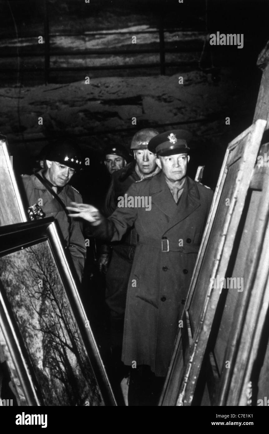 General Dwight D. Eisenhower inspects paintings taken by Nazi soldiers and hidden in a salt mine at Merkers Stock Photo