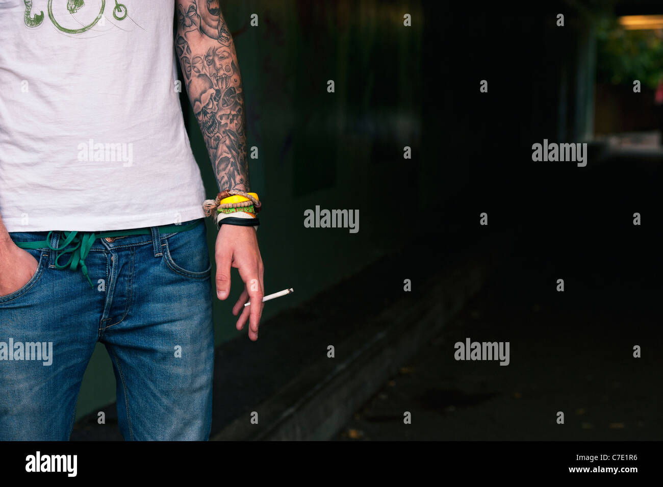 Tattooed Teenager holding a Cannabis Joint Stock Photo