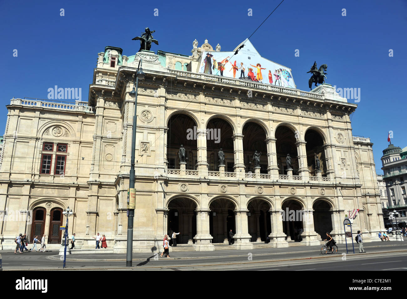 People watching open air live Opera outside the State Opera House in  Karajan Platz Vienna in Austria Stock Photo - Alamy