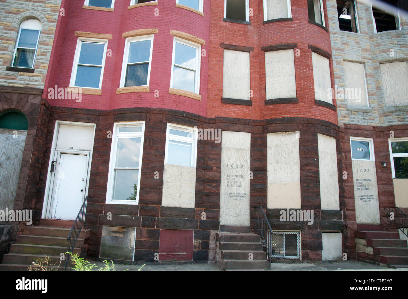 Boarded up row houses on Broadway in Baltimore Maryland USA Stock Photo