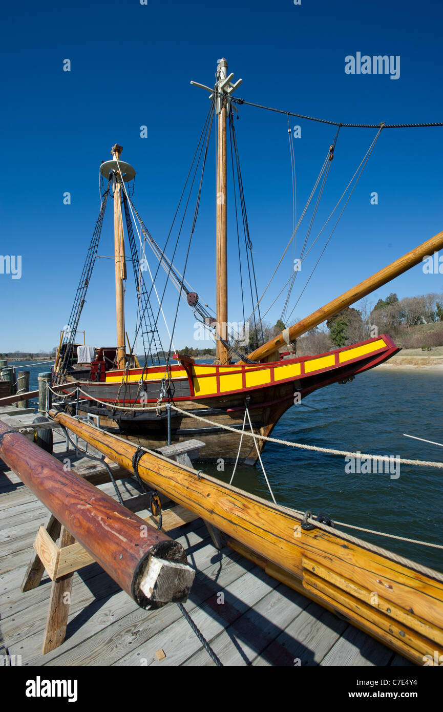 Ship docked and handcrafted spars on dock Stock Photo