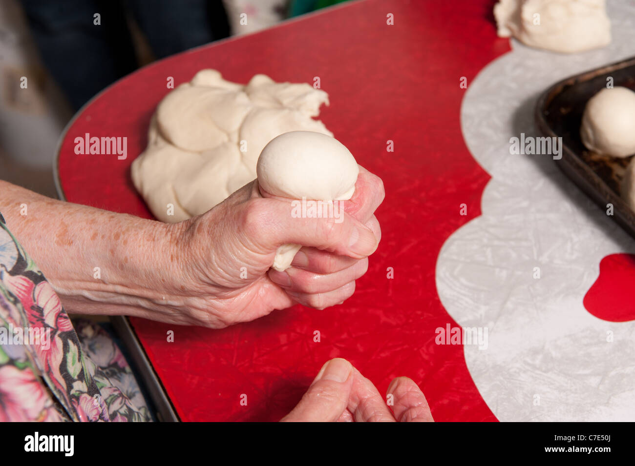 hands rolling dough ball in process of making beaten biscuits Stock Photo