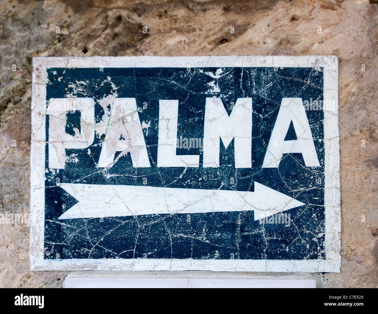 Aged blue road sign with arrow to Palma de Majorca hand painted Stock Photo