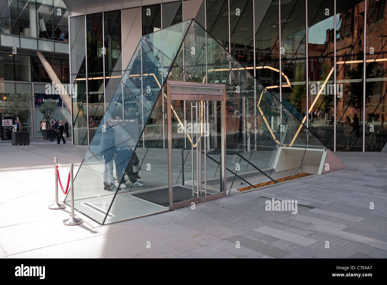 The amazing glass entrance at street level to the Australasia Restaurant, , Spinningfields Square, Manchester, UK. Stock Photo