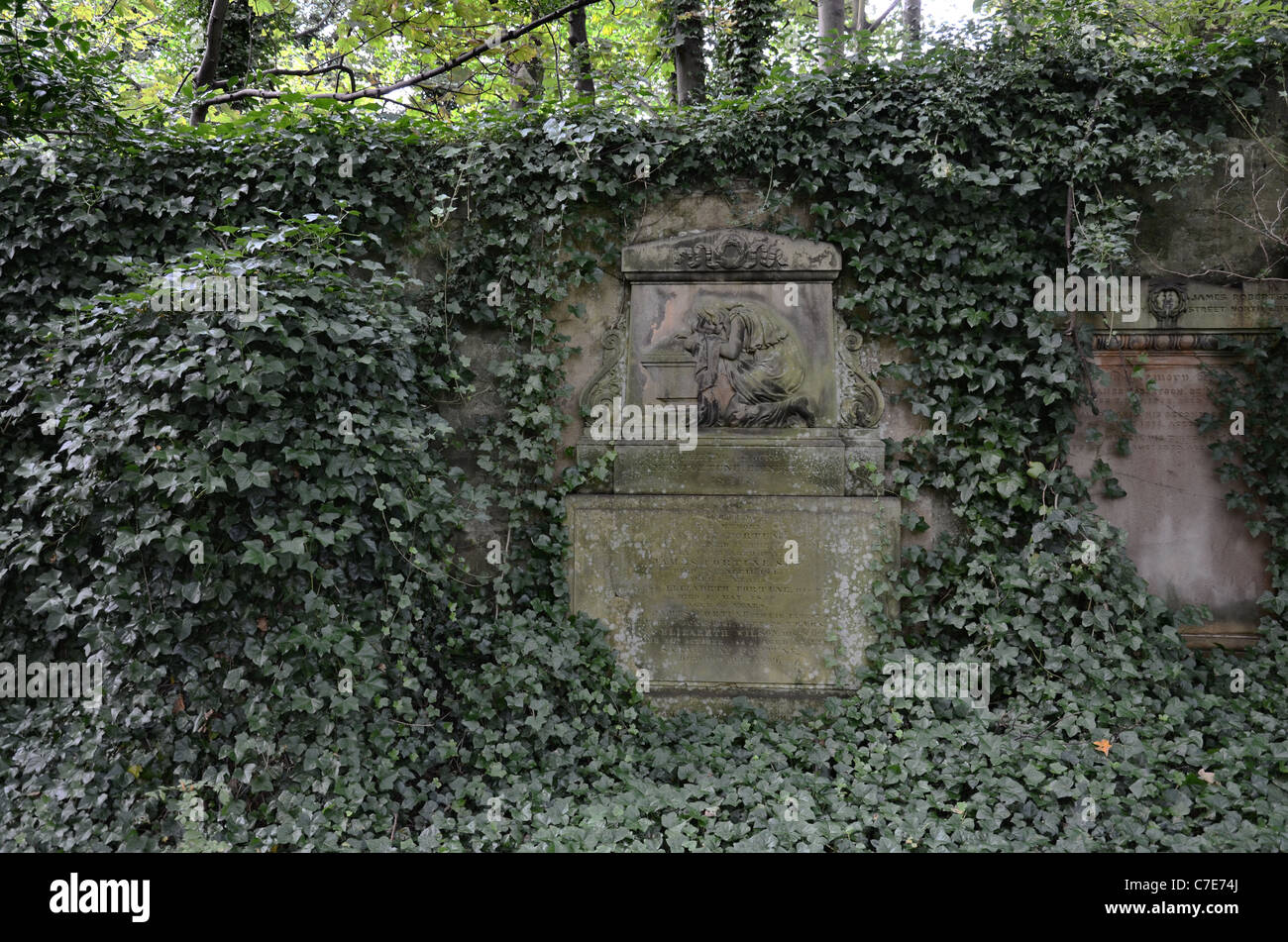 Memorial with the figure of a woman in mourning in an overgrown section of Warriston Cemetery in Edinburgh, Scotland. Stock Photo
