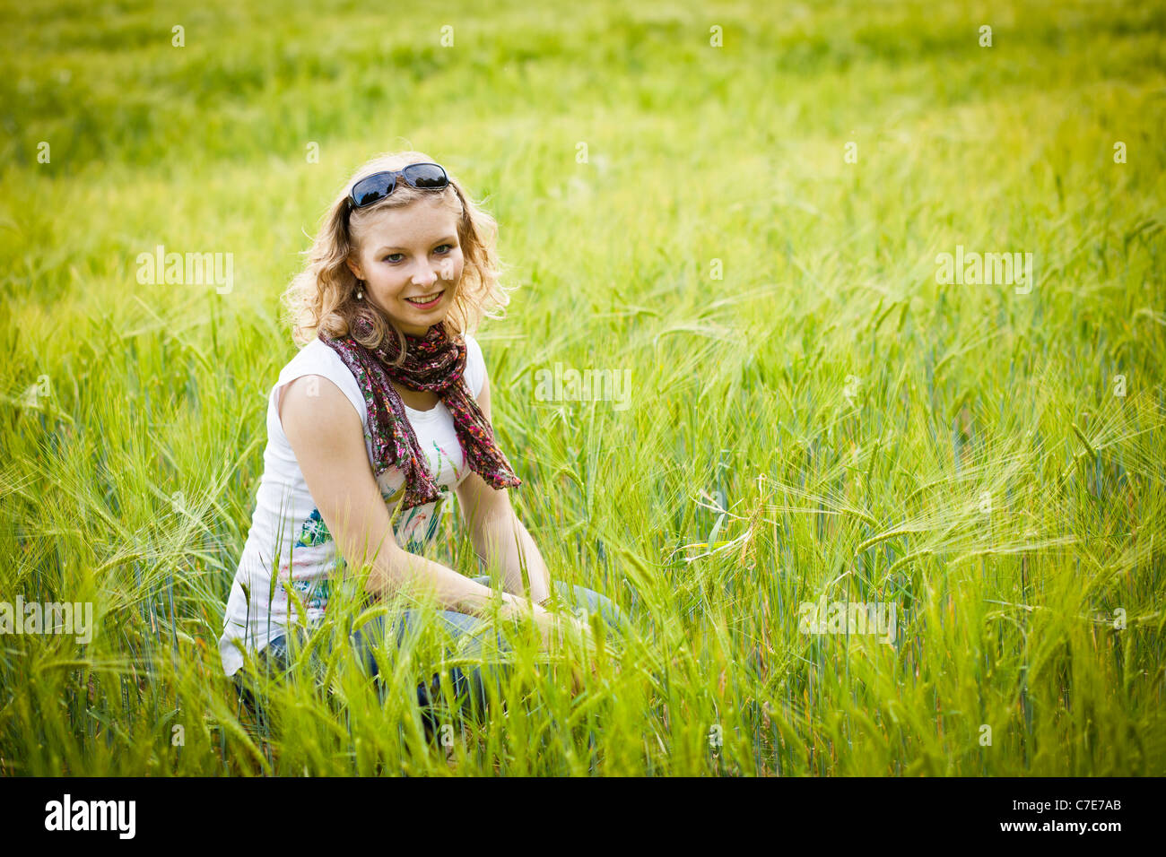 Young girl in green wheat field Stock Photo - Alamy