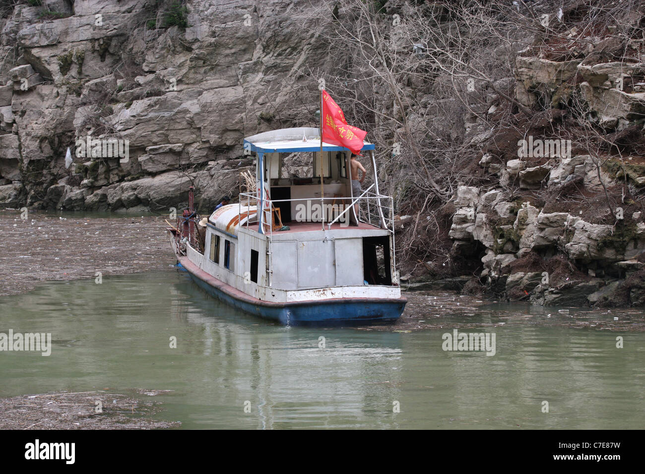 Boat hired to clear out the floating debris, MIsty Gorge, Lesser Three Gorges, China Stock Photo