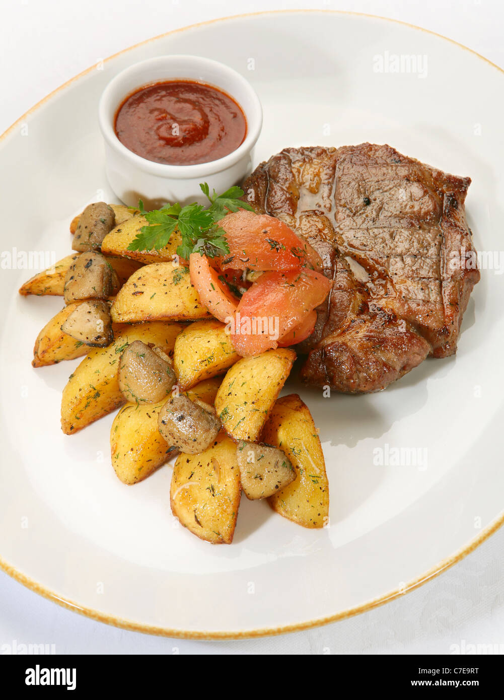 Fried veal steak with potato and sauce Stock Photo