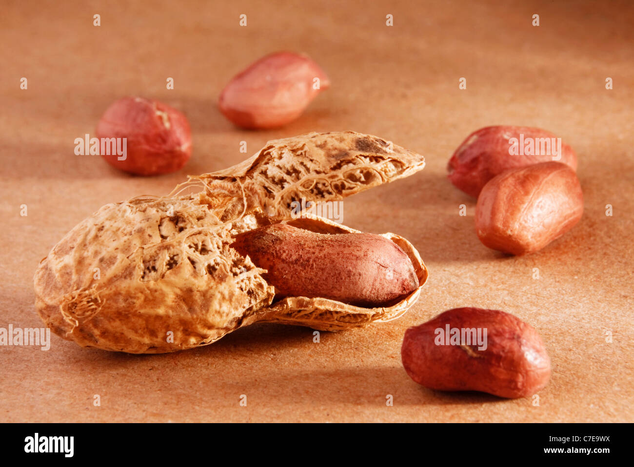 Peanut nut fruit group with shadow on brown background Stock Photo