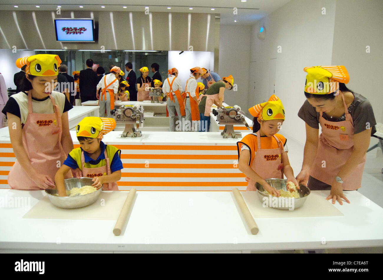 Kids are making their handmade Chikin Ramen during the grand opening of the Nissin Cup Noodles Museum. Stock Photo