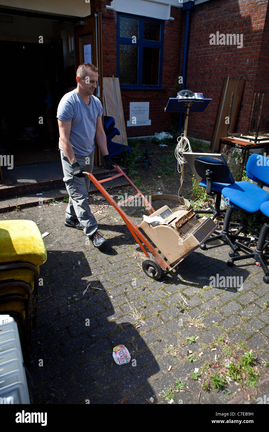 Clearance of cash-till being wheeled out from closed down social club. Stock Photo