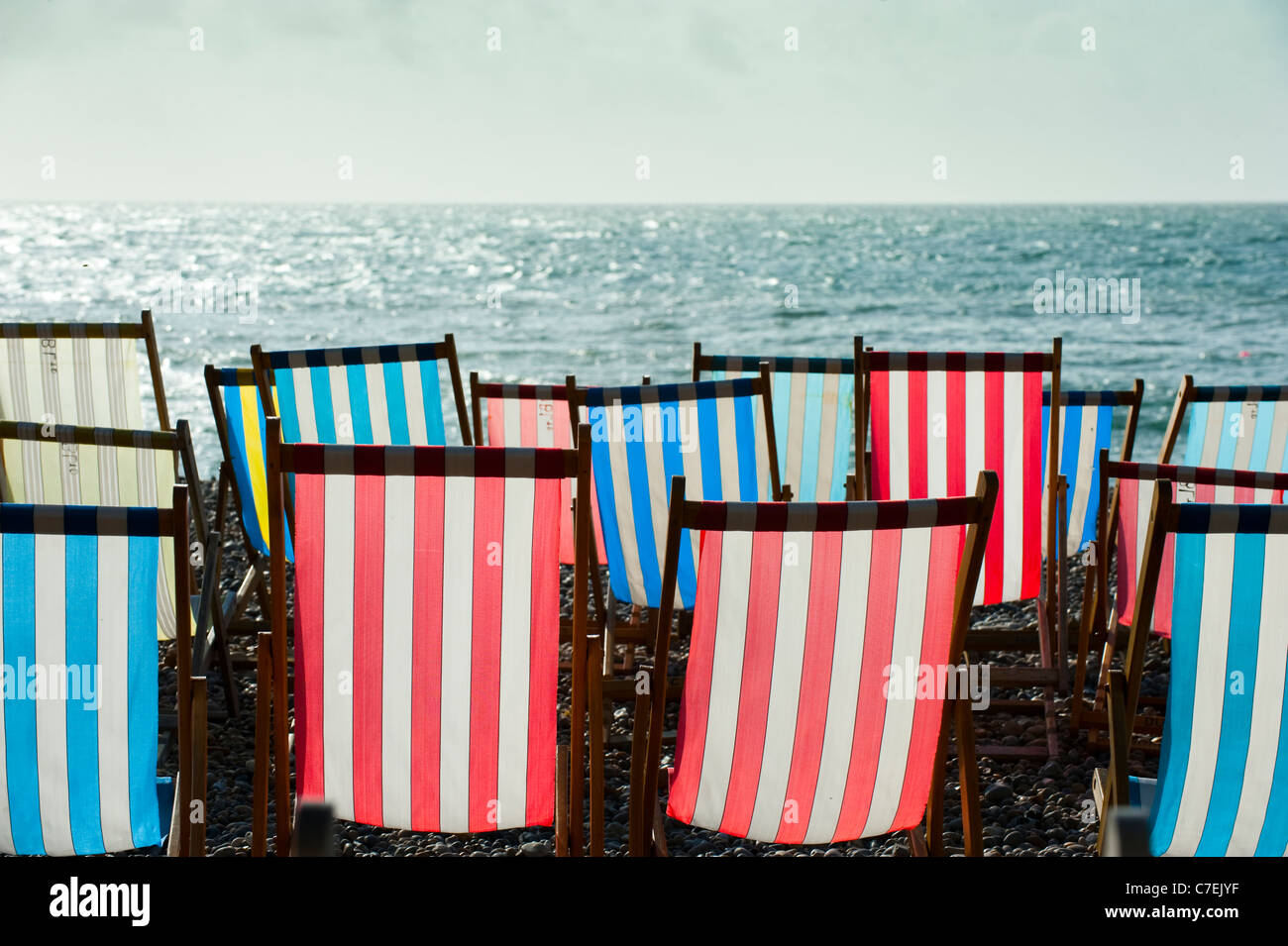 Deck chairs on beach at Beer Devon England Stock Photo